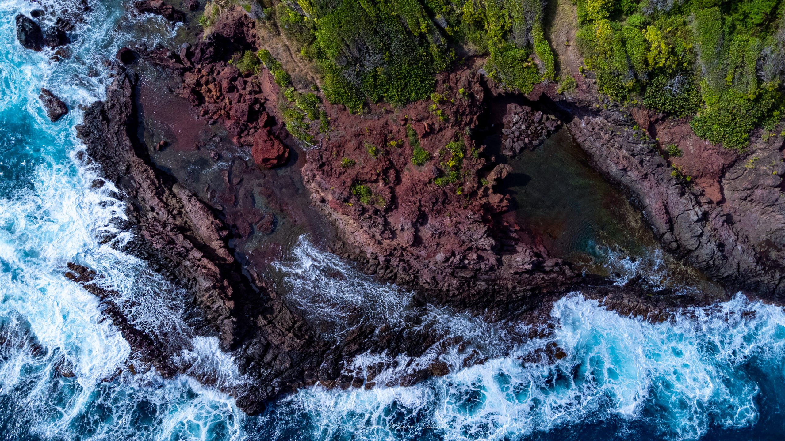 Natural made salt pond pool with waves crashing